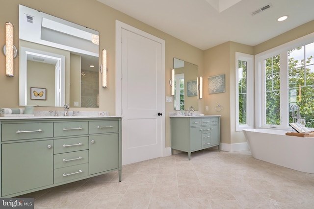 bathroom with vanity, tile patterned floors, and a tub