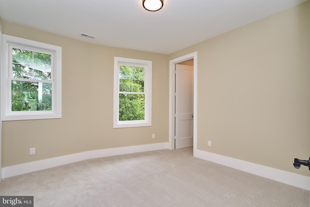 carpeted spare room with a healthy amount of sunlight