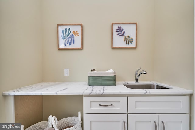 clothes washing area with sink