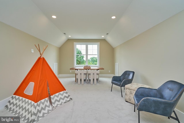 playroom featuring lofted ceiling and light carpet