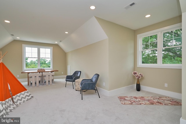 sitting room with vaulted ceiling and light carpet