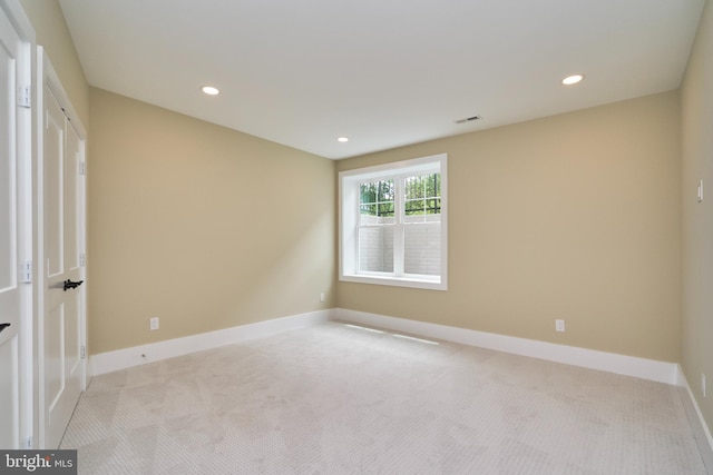 unfurnished room with light colored carpet