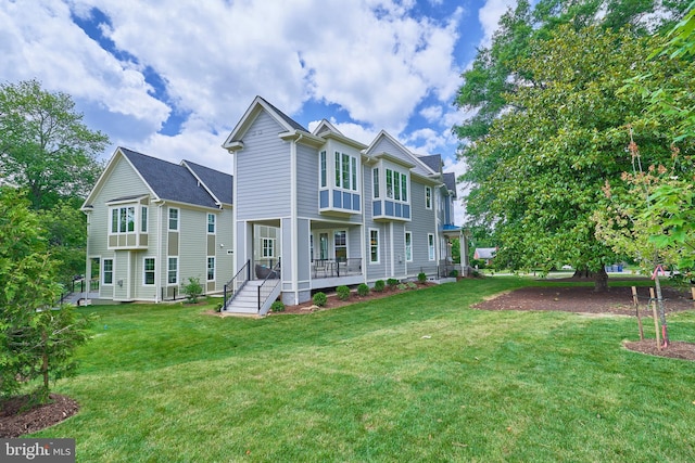 back of property featuring a porch and a yard