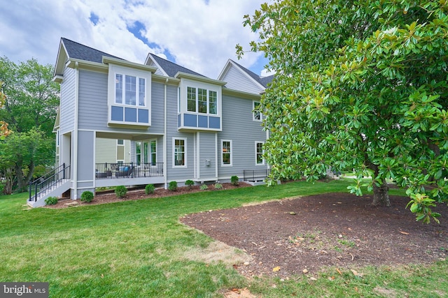 rear view of house with a lawn