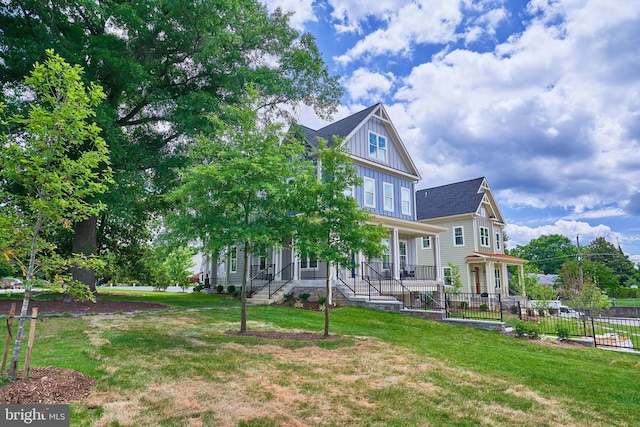 view of front of home featuring a front yard and covered porch