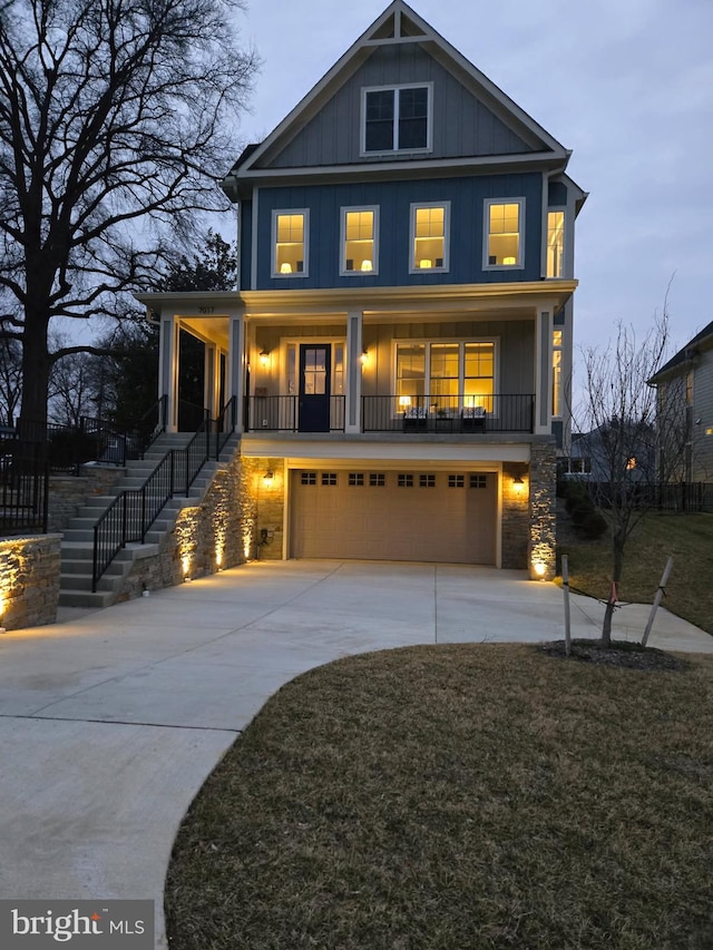 view of front of home featuring a garage, a yard, and covered porch