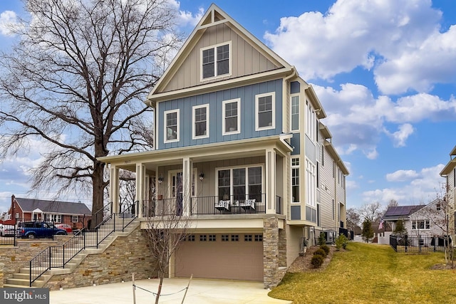 view of front of home featuring a garage, a front lawn, and a porch