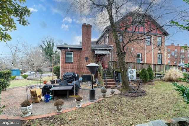 back of property featuring a yard and a patio area