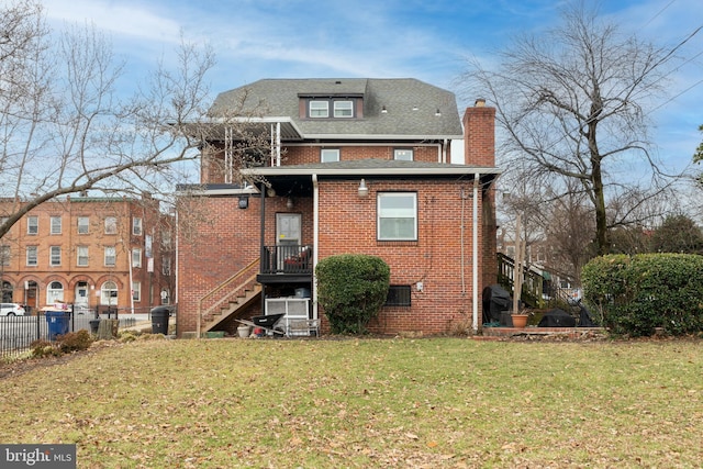 back of property with a lawn