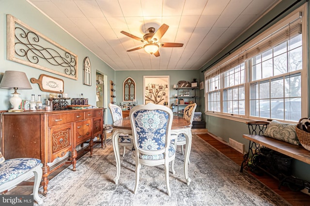 dining space with wood-type flooring and ceiling fan