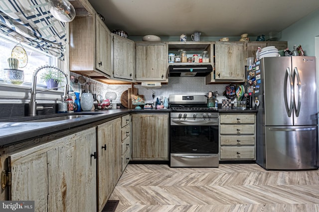 kitchen with appliances with stainless steel finishes, sink, light brown cabinetry, and decorative backsplash