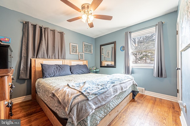 bedroom with hardwood / wood-style floors and ceiling fan