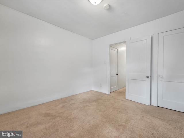 interior space featuring light carpet