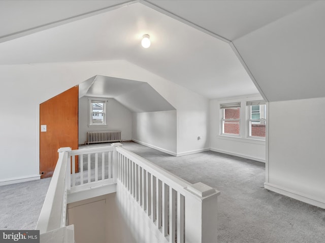 bonus room with light carpet, radiator heating unit, and vaulted ceiling