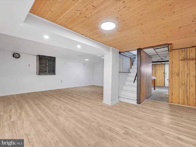 basement with light hardwood / wood-style flooring and wooden ceiling