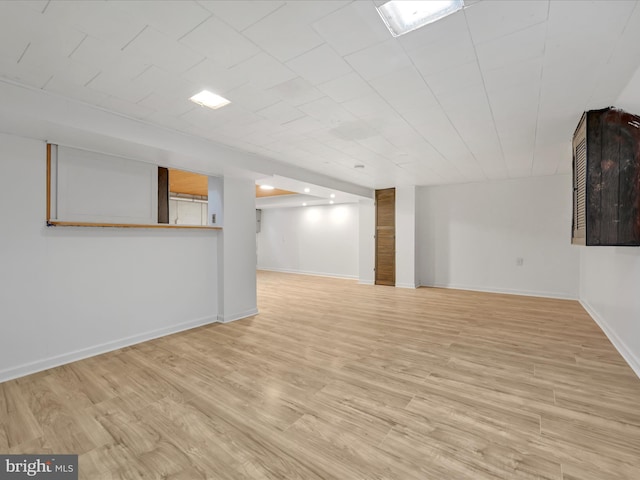 basement with light hardwood / wood-style floors