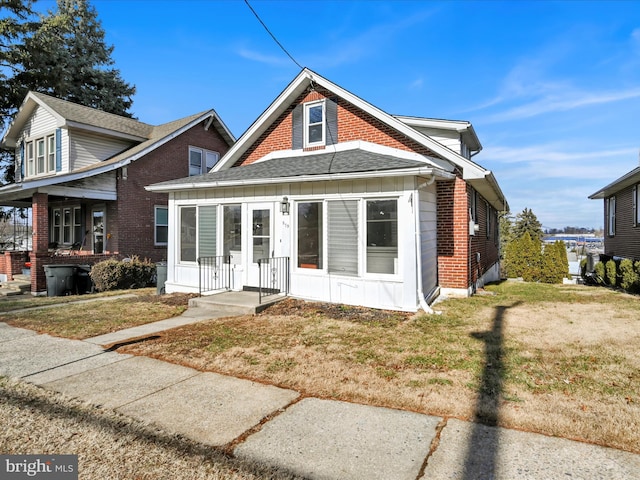 bungalow-style house featuring a front yard