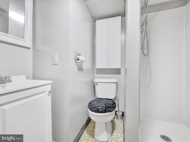 bathroom with vanity, walk in shower, and toilet