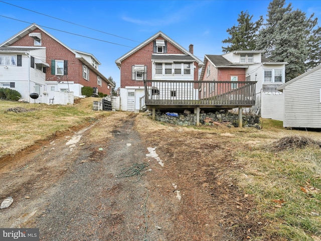 back of property with a wooden deck