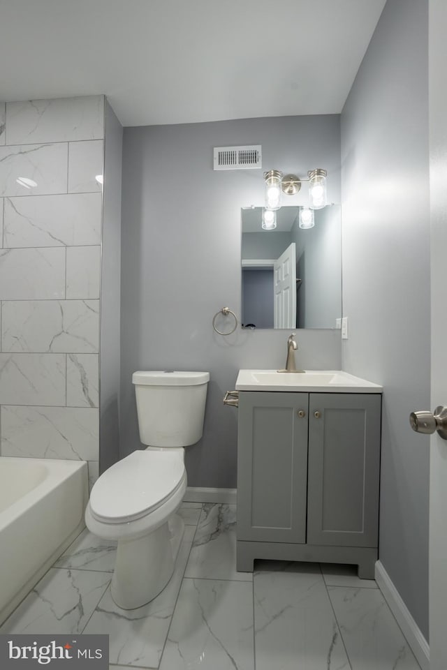 full bathroom with vanity, tiled shower / bath, and toilet