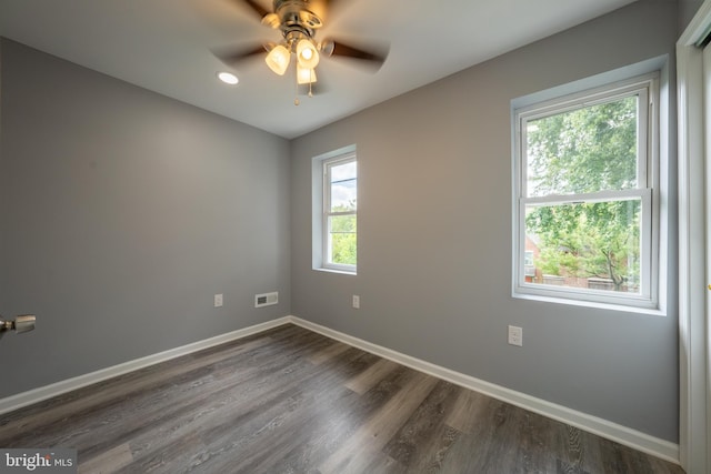 unfurnished room with dark wood-type flooring and ceiling fan