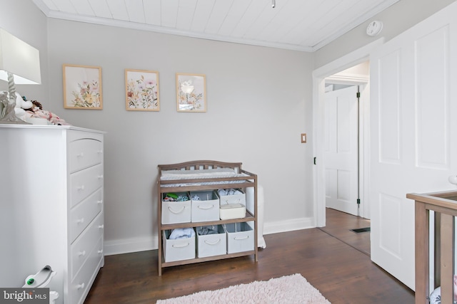 bedroom featuring ornamental molding, dark wood-type flooring, and wood ceiling