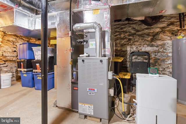 utility room featuring water heater