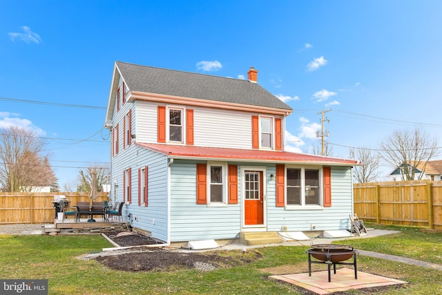 view of front of home featuring a fire pit, a front yard, and a deck