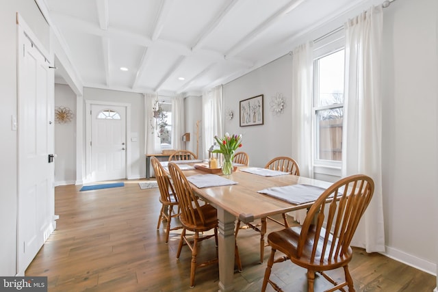 dining space featuring dark wood-type flooring and beamed ceiling