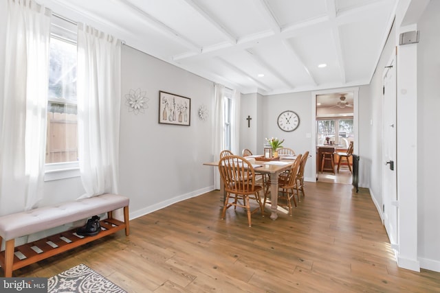 dining room with hardwood / wood-style flooring and beamed ceiling