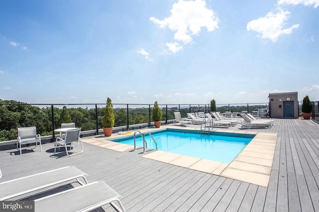 pool featuring fence and a wooden deck