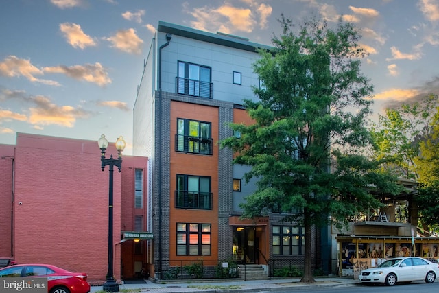 view of outdoor building at dusk