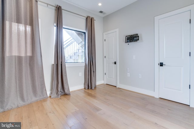 unfurnished room with light hardwood / wood-style floors