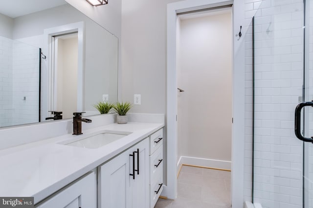 bathroom featuring tile patterned floors, an enclosed shower, and vanity