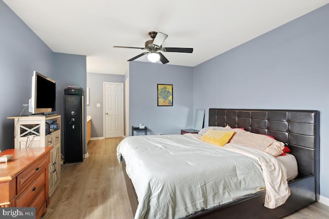 bedroom with light hardwood / wood-style floors and ceiling fan