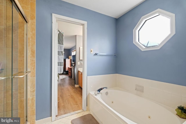 bathroom with tile patterned flooring and plus walk in shower