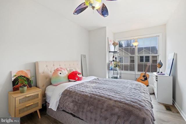 bedroom with hardwood / wood-style floors and ceiling fan