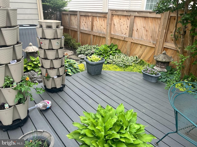 wooden terrace featuring central AC unit