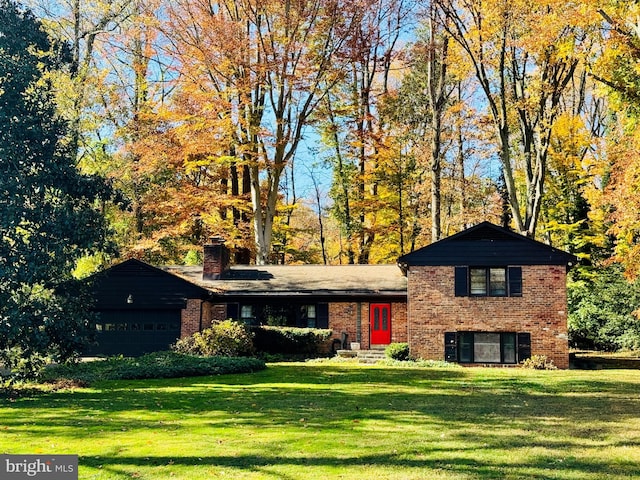 split level home with a garage and a front yard