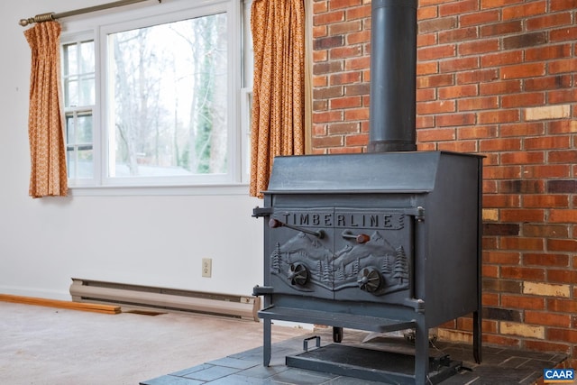 interior details with a baseboard radiator and a wood stove