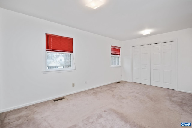 unfurnished bedroom with carpet floors and a closet