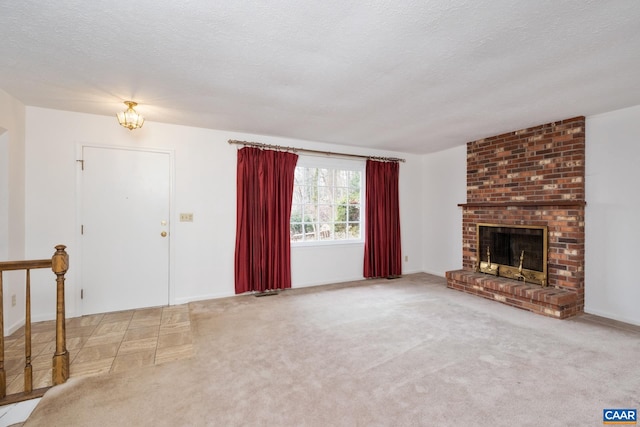 unfurnished living room with light colored carpet, a fireplace, and a textured ceiling