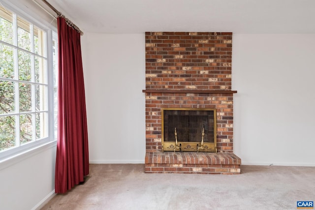 unfurnished living room featuring carpet and a fireplace