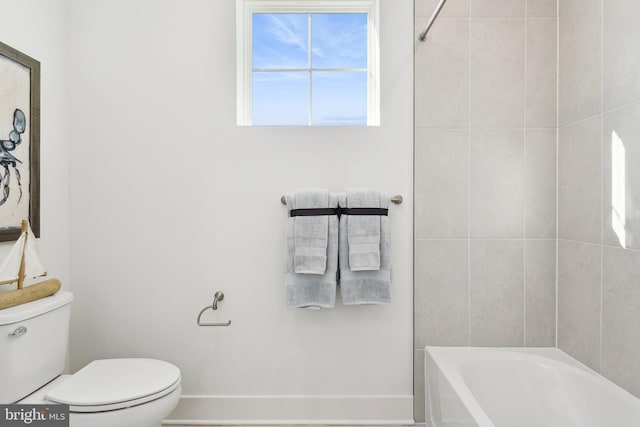 bathroom with shower / bathing tub combination and toilet