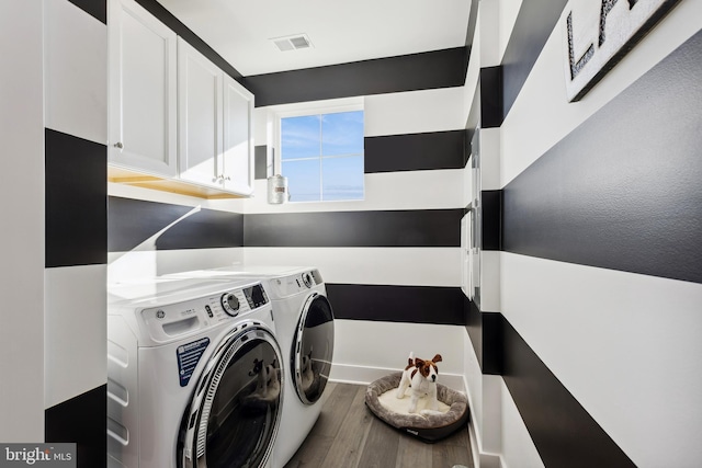 clothes washing area with hardwood / wood-style flooring and washer and clothes dryer