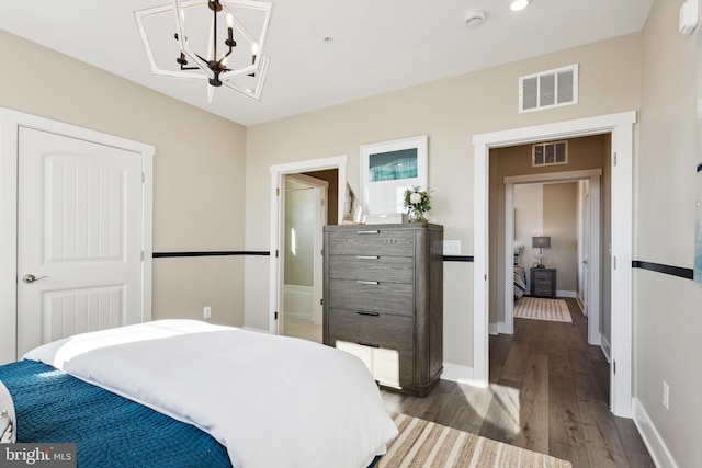 bedroom featuring hardwood / wood-style flooring and a notable chandelier