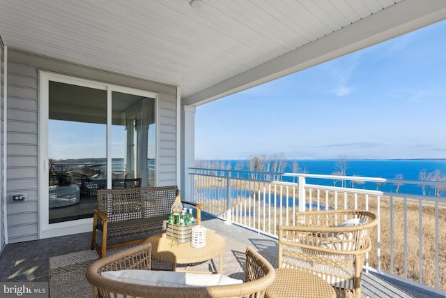 balcony featuring a water view and a view of the beach