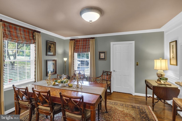 dining area with crown molding, wood-type flooring, and a wealth of natural light