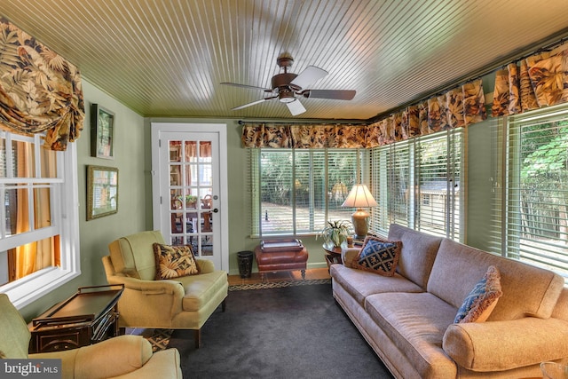 sunroom featuring wooden ceiling and ceiling fan