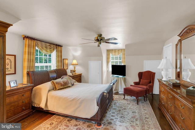 bedroom with ceiling fan, light hardwood / wood-style floors, and multiple windows